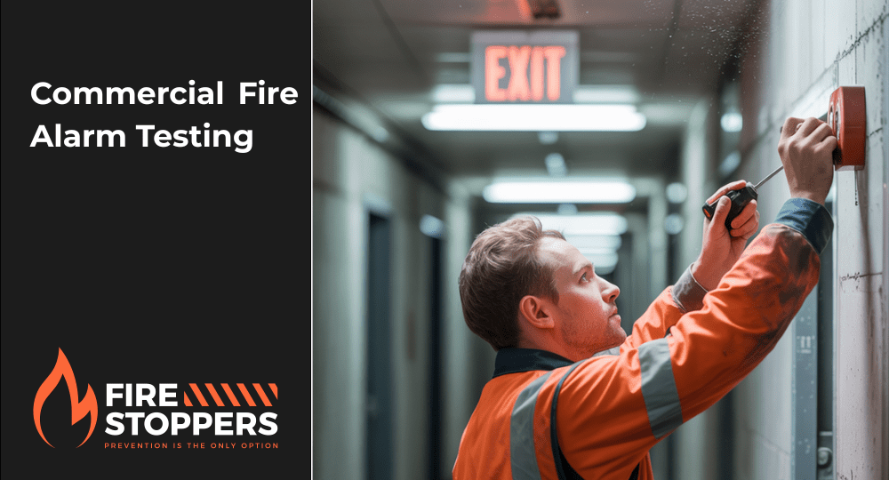 firestopper team member fixing a commercial fire alarm | Firestoppers