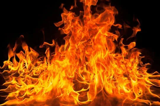 image of fire rising up from ground on a black background